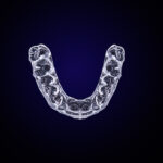 Aerial view of Invisalign clear aligners on a navy blue background
