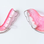 Aerial view of pink removable orthodontic retainers to keep teeth in place